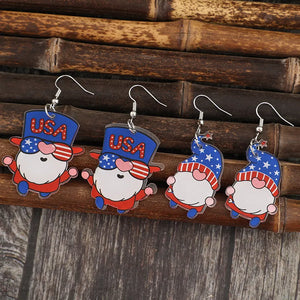 Patriotic gnome drop earrings in royal blue acrylic with USA hats and star patterns.