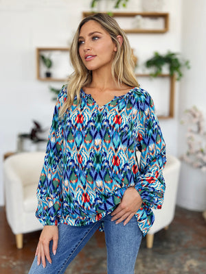 Prismatic ikat blouse with voluminous sleeves in blue and green, featuring a V-neck and relaxed fit.