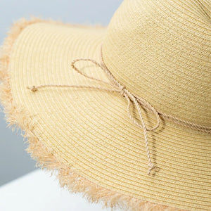 Beige straw sun hat with frayed brim and tie detail