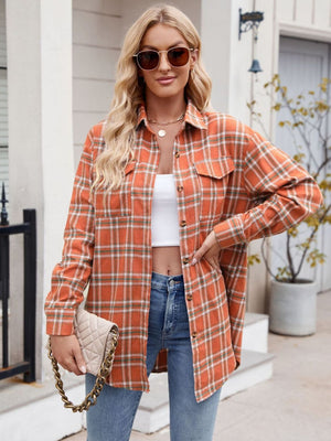 Orange plaid overshirt with patch pockets and button front, styled with jeans.