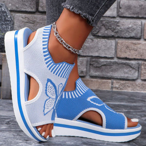 Blue and white open-toe wedge sandals with butterfly motif and mesh detail