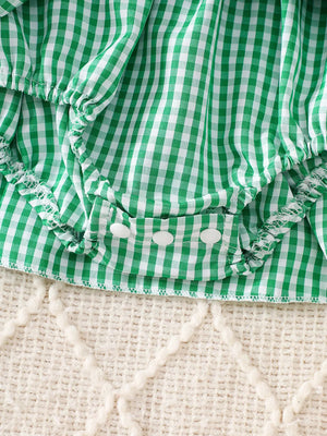 Green gingham baby one-piece with white buttons and ruffled trim
