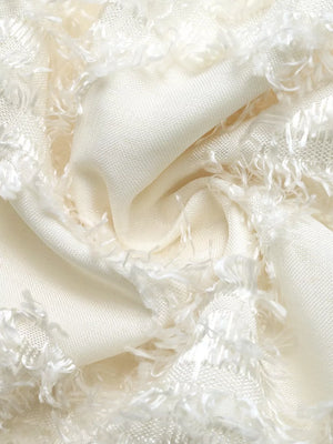 Chic textured mini dress fabric detail in cream with frayed trim.