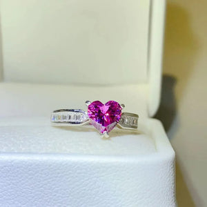 Silver ring with a heart-cut pink gemstone and baguette accents