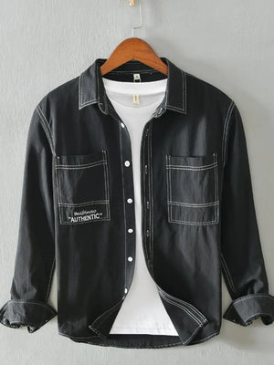 Black men's casual shirt with contrast stitching and two chest pockets.