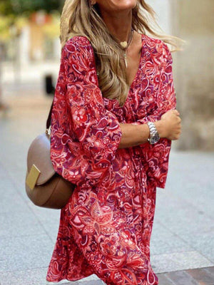 Red paisley print dress with balloon sleeves and a V-neck, styled with a brown crossbody bag.