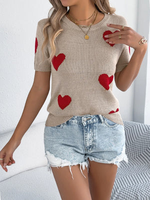 Tan knit t-shirt with red heart pattern, short sleeves, and crew neck.