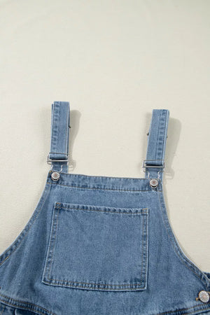Denim overalls with adjustable straps, silver hardware, and a front bib pocket.