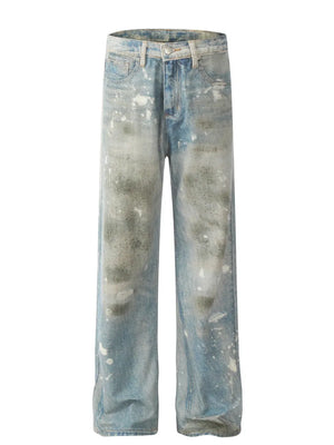 Distressed wash wide leg denim jeans in medium blue with paint splatters and fading.