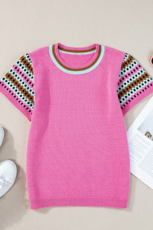 Pink knit top with geometric patterned sleeves and striped neckline