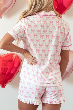 Printed bow pajama set in blush pink with ruffle hem shorts and short sleeve top.