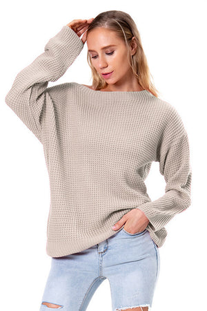 Off-shoulder waffle knit sweater in beige with slouchy fit and boat neck.