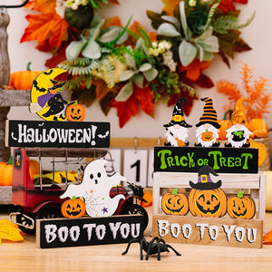 Halloween gnome trio display with pumpkins, ghost, and spider decor.