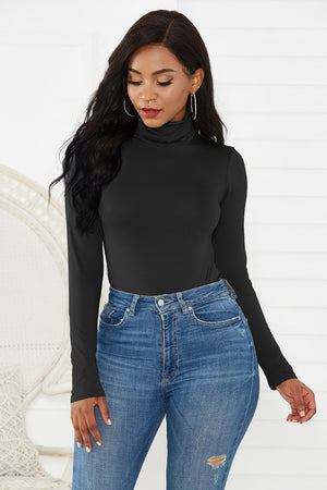 Black turtleneck thong bodysuit with long sleeves, styled with high-waisted jeans.