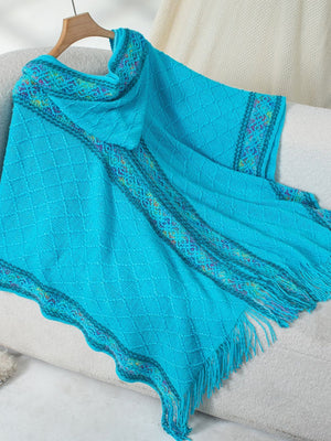 Sky blue knit hooded wrap with diamond pattern and colorful embroidered trim.