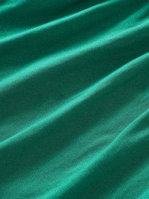 Green A-line baby dress in cotton blend fabric with subtle texture.