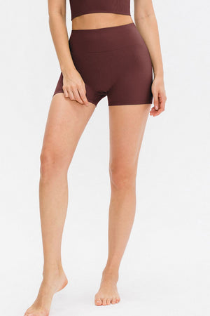 Burgundy ribbed sculpting active shorts with a high waist and seamless design.