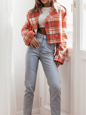 Boxy plaid cropped blazer in orange with button detail, worn with light wash jeans.