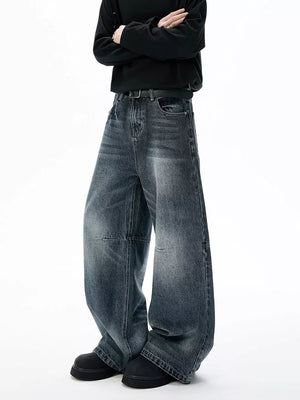 Belted dark-wash wide-leg jeans with unique paneled design and a relaxed fit.