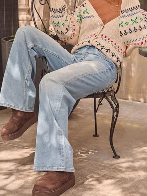 Light blue denim high-waisted jeans with a wide leg, buttoned front, and front pockets.