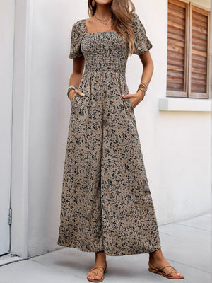Smocked bodice floral palazzo jumpsuit in taupe with short puff sleeves and square neckline.