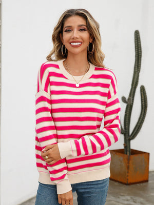 Pastel stripe crewneck knit sweater in pink and cream acrylic with crew neck and long sleeves.