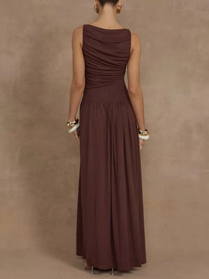 Brown ruched sleeveless maxi dress with a gathered bodice and flowing skirt.