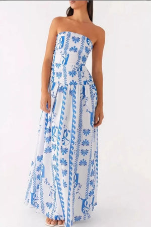 Strapless maxi dress in white with blue floral print and flowing skirt.