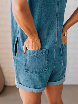 Denim romper with cuffed shorts, back pockets, and zipper closure.
