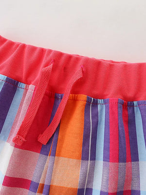Toddler shorts with elastic waistband and drawstring, featuring a colorful plaid pattern.