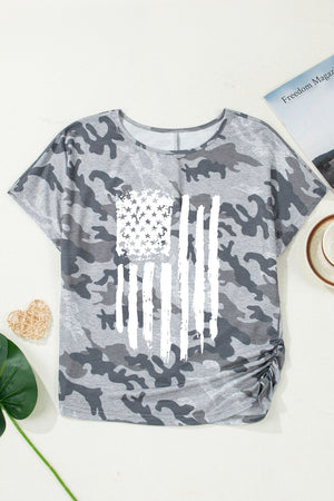 Grey camouflage crew neck t-shirt with distressed American flag graphic and ruched side detail.