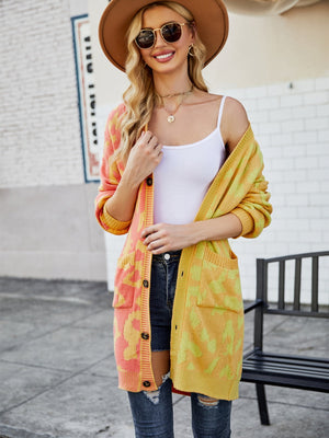 Colorblock leopard knit duster cardigan in acrylic with button front and pockets.