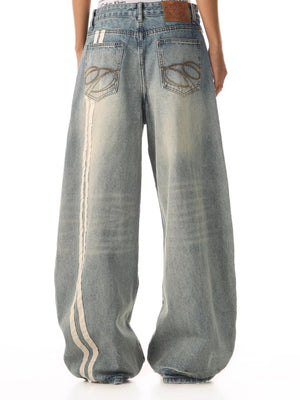 Men's vintage wide leg jeans in blue denim with white stripe detail and baggy fit.