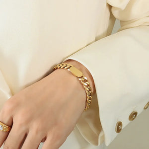 Gold chunky curb chain ID bracelet with a smooth tag detail.