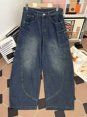 Classic vintage wash wide-leg jeans in dark blue cotton with angular pockets.