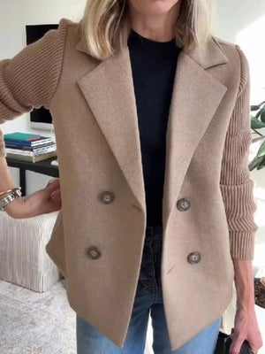 Tan double-breasted trench coat with knit sleeves and button closure.