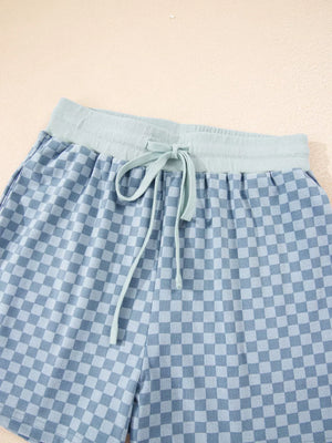 Light blue checkerboard shorts with a light blue drawstring waist and elastic band.
