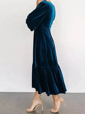 Peacock blue velvet midi dress with tiered skirt and bell sleeves.