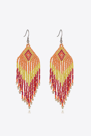 Beaded diamond fringe earrings in orange, yellow, red, and pink with gold accents.
