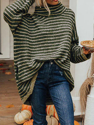 Dark green and gold striped oversized turtleneck sweater with slouch pockets, worn with jeans.