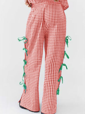 Gingham wide-leg trousers in Scarlet with green bow details on the side seams.
