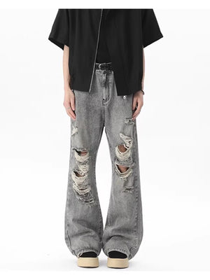 Men's light gray distressed wide-leg jeans with frayed details.