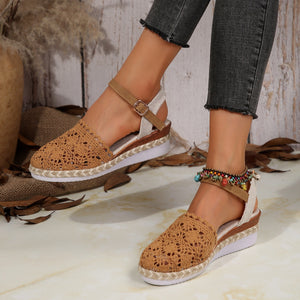 Brown espadrille wedge sandals with crochet floral detail and adjustable ankle strap.