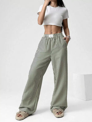 Navy striped high-waisted wide-leg pants with drawstring detail.