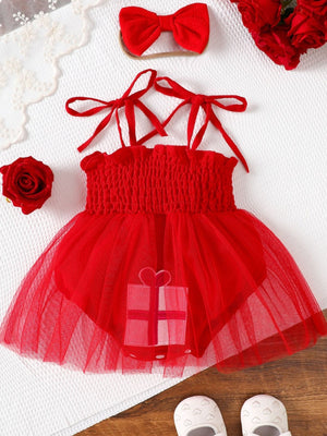Red baby bodysuit dress with smocked bodice, tulle skirt, gift applique, and tie straps.
