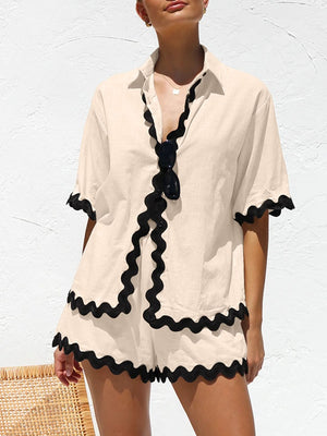 Tan pajama set with black wavy trim on collar, sleeves, and shorts.