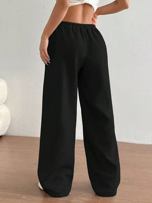 Black wide-leg maternity joggers with elastic waistband and relaxed fit.