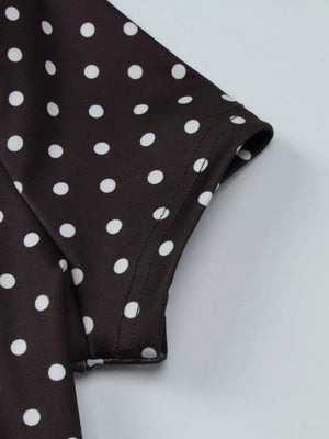 Brown polka dot mini dress with short sleeves and cut-out detail.