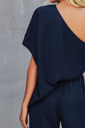 Dark blue asymmetric jumpsuit with drape sleeves and wide legs