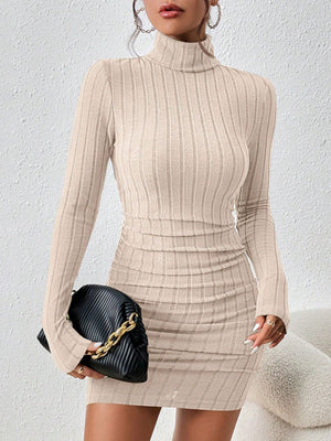 Apricot ribbed turtleneck bodycon mini dress with long sleeves and ruched detail.
